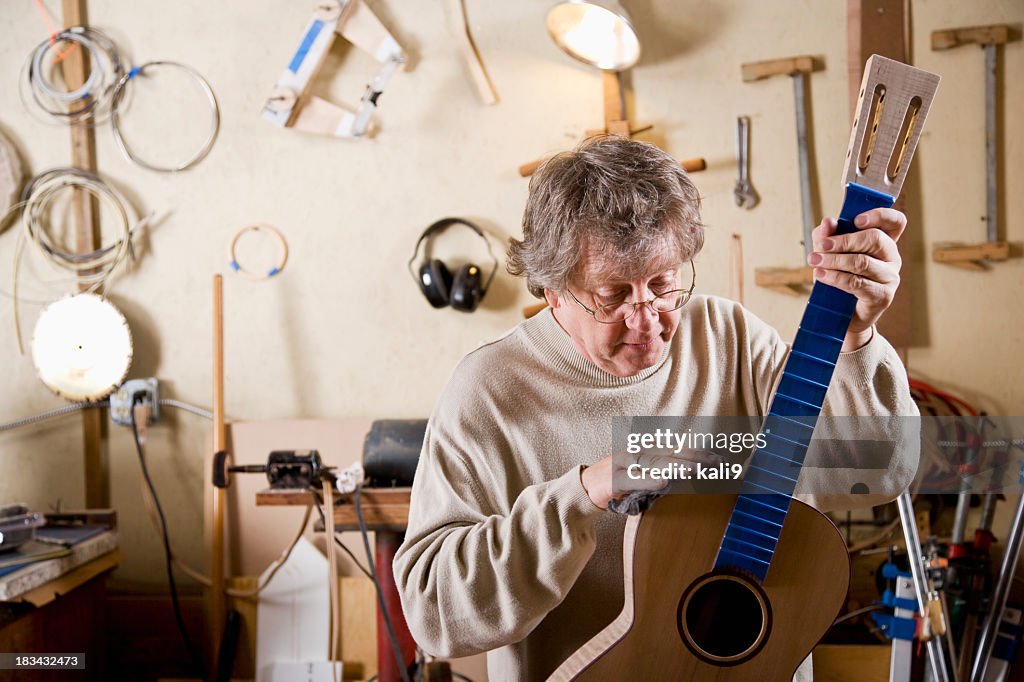 Craftsman working on guitar