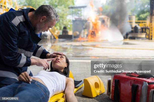 emergency response: firefighter providing cpr to save a life in fire incident - fire extinguisher inspection stock pictures, royalty-free photos & images