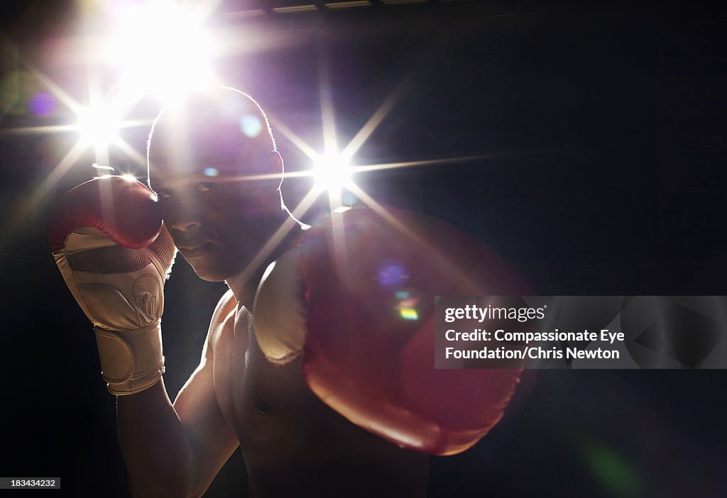 Boxer wearing gloves looking intimidating