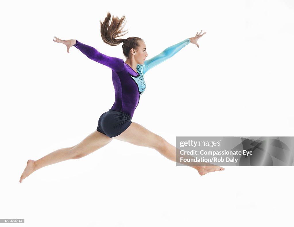Female gymnast jumping in mid-air