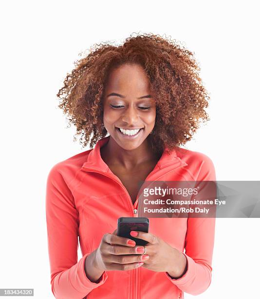 smiling woman texting on mobile phone - look down - fotografias e filmes do acervo