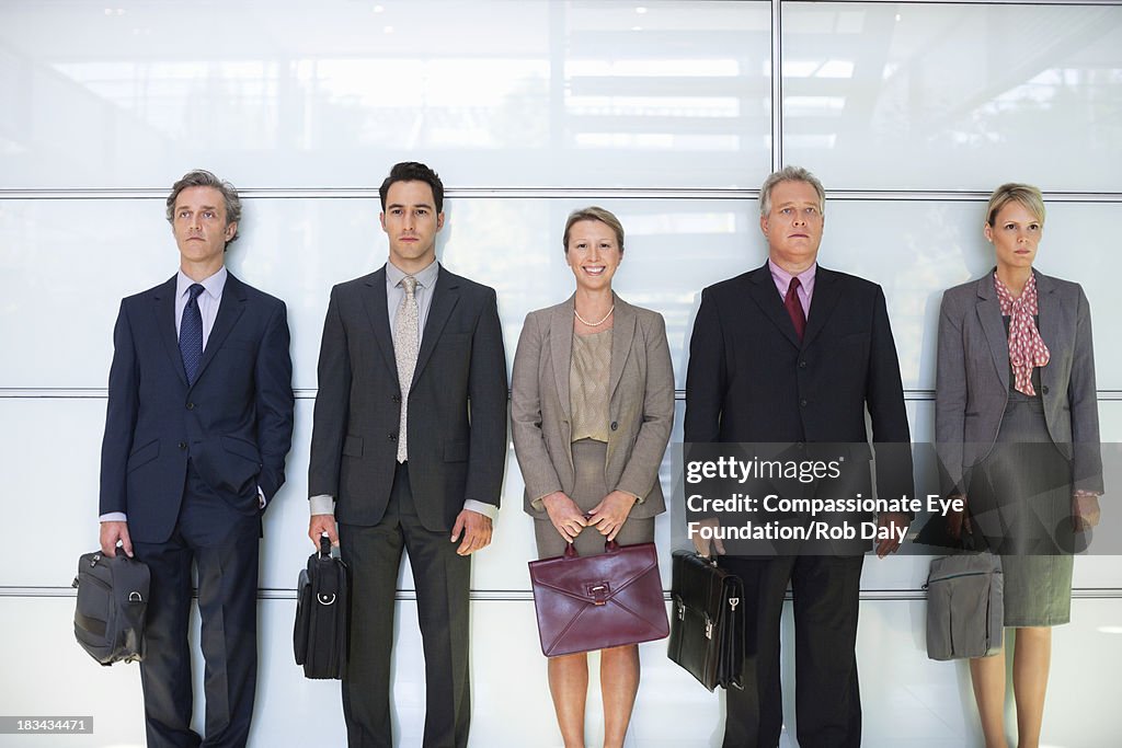 Business people in lobby standing in a line