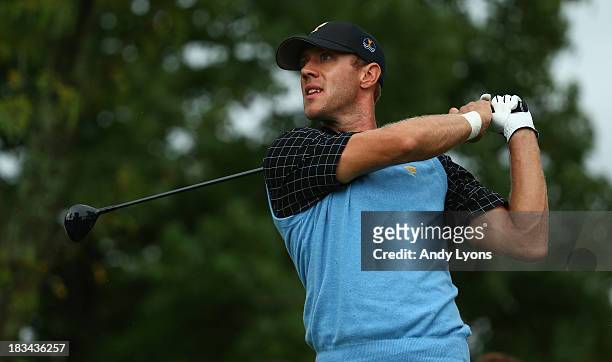 Graham DeLaet of Canada and the International Team watches his tee shot on the fifth hole during the Day Four Singles Matches at the Muirfield...