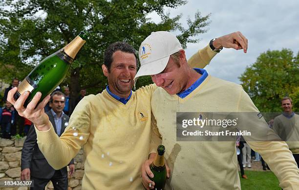 Gregory Bourdy and Mikko Ilonen of the European team celebrate with champagne after winning the Seve Trophy at Golf de Saint-Nom-la-Breteche on...