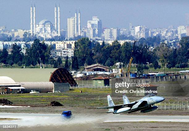 An F-15 fighter jet glides in for a landing in front of Adana's main mosque March 7, 2003 at Incirlik Air Force Base in Turkey. Activity at Incirlik,...