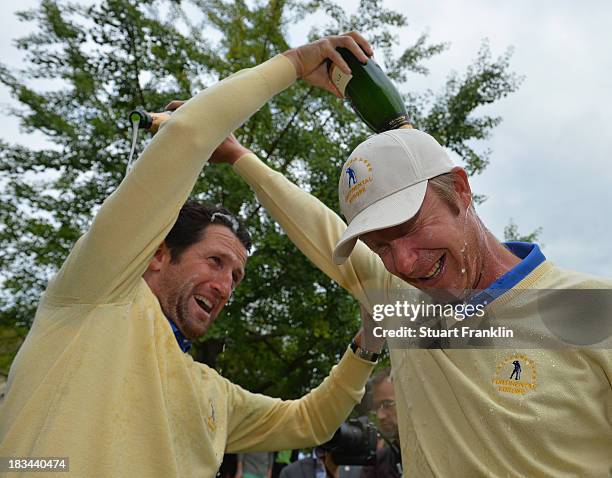 Gregory Bourdy and Mikko Ilonen of the European team celebrate with champagne after winning the Seve Trophy at Golf de Saint-Nom-la-Breteche on...