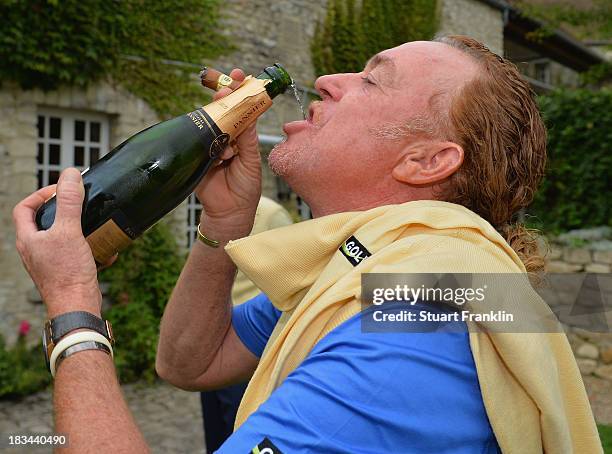 Miguel Angel Jimenez of the European team celebrate with champagne after winning the Seve Trophy at Golf de Saint-Nom-la-Breteche on October 5, 2013...