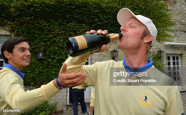 Mikko Ilonen of the European team celebrate with champagne after winning the Seve Trophy at Golf de Saint-Nom-la-Breteche on October 5, 2013 in...