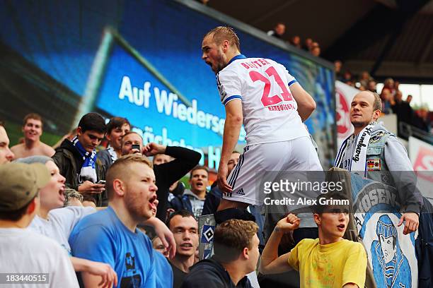 Maximilian Beister of Hamburg celebrates with the fans after the Bundesliga match between 1. FC Nuernberg and Hamburger SV at Grundig Stadium on...