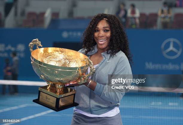 Serena Williams of the United States poses with the trophy after winning her women's final match against Jelena Jankovic of Serbia on day nine of the...
