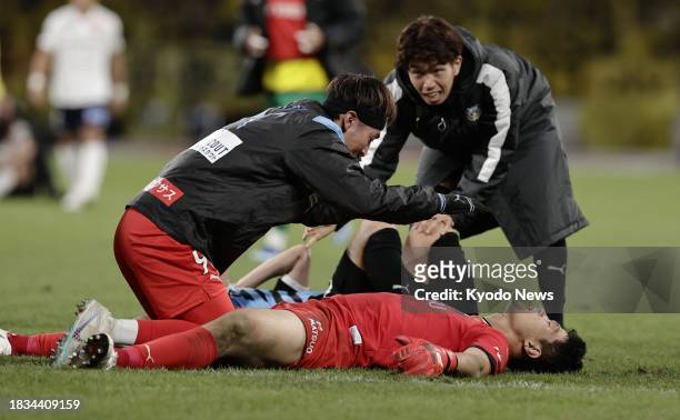 Kawasaki Frontale goalkeeper Jung Sung Ryong lies on his back after saving a shot from Kashiwa Reysol's Kenta Matsumoto during a penalty shootout in...