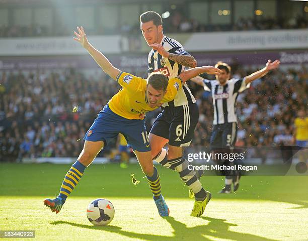 Aaron Ramsey of Arsenal battles with Liam Ridgewell of West Bromwich Albion during the Barclays Premier League match between West Bromwich Albion and...