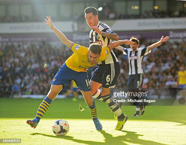 Aaron Ramsey of Arsenal battles with Liam Ridgewell of West Bromwich Albion during the Barclays Premier League match between West Bromwich Albion and...