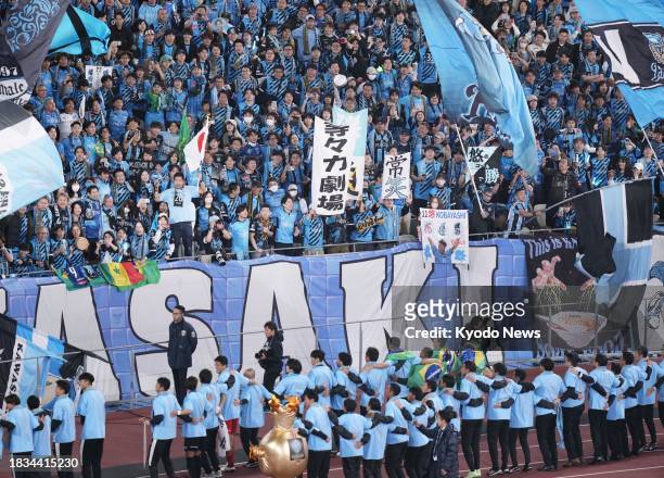 Kawasaki Frontale players celebrate with supporters after the team's victory over Kashiwa Reysol in the Emperor's Cup football final on Dec. 9 at...