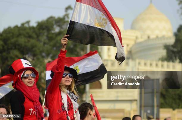 Egyptian women wave national flags during the celebration marking the 40th anniversary of the 1973 victory over Israel around the Ittihadiya...