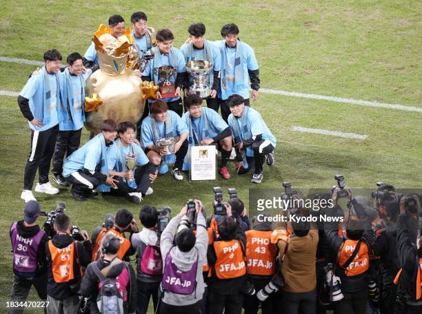 Kawasaki Frontale players pose for a photo after the team's victory over Kashiwa Reysol in the Emperor's Cup football final on Dec. 9 at Tokyo's...