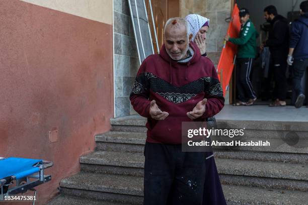 People mourn as they collect the bodies of Palestinians killed in an airstrike on December 06, 2023 in Khan Yunis, Gaza. Israel stepped up its...