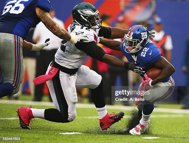 David Wilson of the New York Giants is tackled on his own goal line by Cedric Thornton of the Philadelphia Eagles in the second quarter during their...