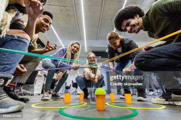 team building game at casual office! - happy colleagues doing team building activity imagens e fotografias de stock