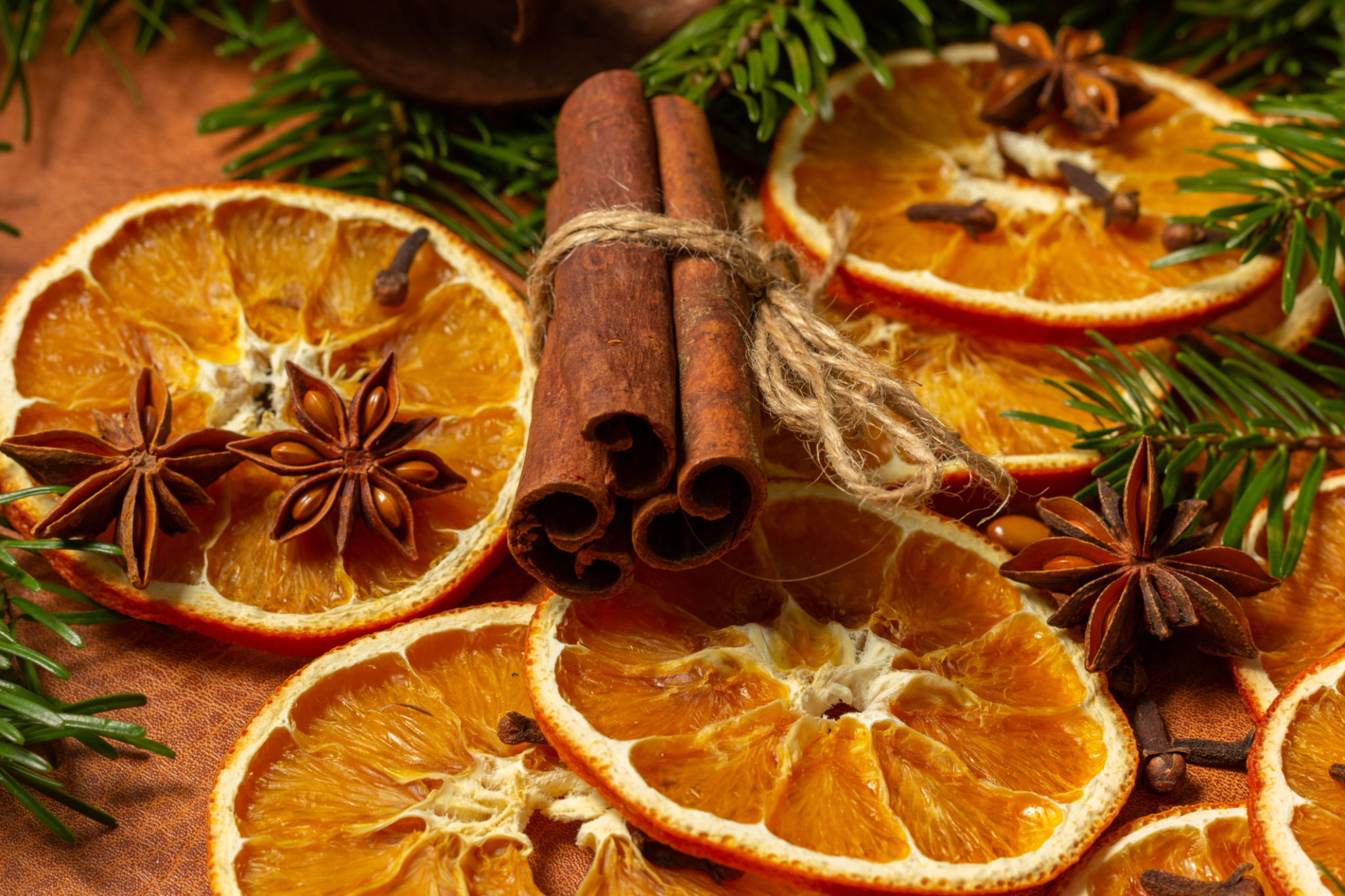 Christmas nature arrangement with dried orange pieces, cinnamon sticks, pine cones, star anise and Christmas tree branches Christmas nature arrangement with dried orange pieces, cinnamon sticks, pine cones, star anise and Christmas tree branches