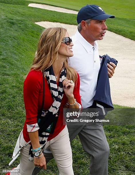 Team Captain Fred Couples walks off the 18th green with his girlfriend Nadine Moze after the U.S. Team defeated the International Team 18.5 to 15.5...