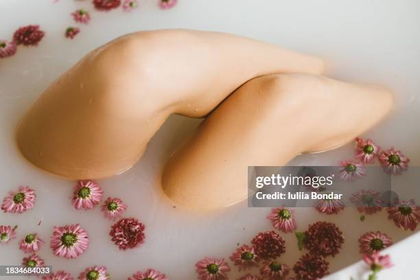 close up of young beautiful woman taking a bath - milchbad stock-fotos und bilder