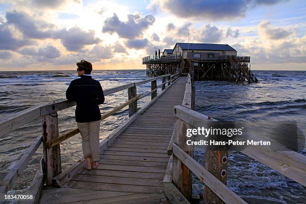 woman at sunset on the beach - sankt peter ording stock pictures, royalty-free photos & images