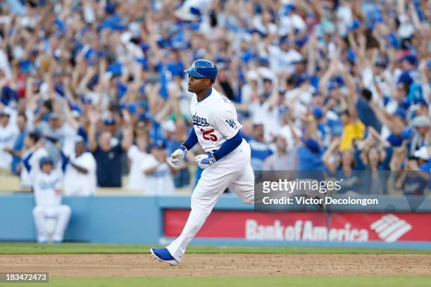 Carl Crawford of the Los Angeles Dodgers rounds the bases after hitting a three-run home run in the second inning against the Atlanta Braves during...