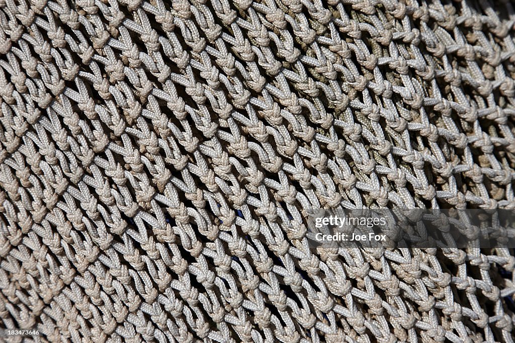 Close up of holes in small fish fishing nets