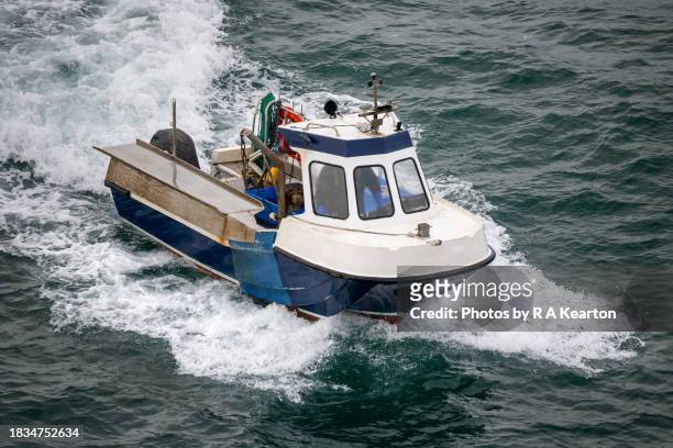 a small fishing boat off the coast of, north wales - irish sea stock-fotos und bilder