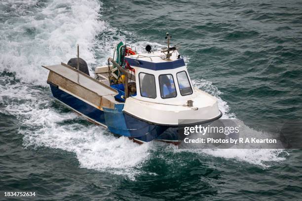 a small fishing boat off the coast of, north wales - irish sea stock pictures, royalty-free photos & images