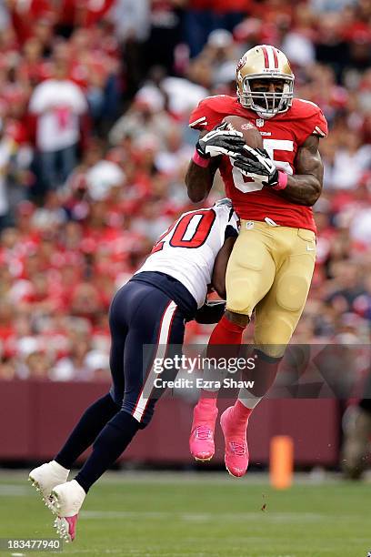 Vernon Davis of the San Francisco 49ers catches a pass against Ed Reed of the Houston Texans during their game at Candlestick Park on October 6, 2013...