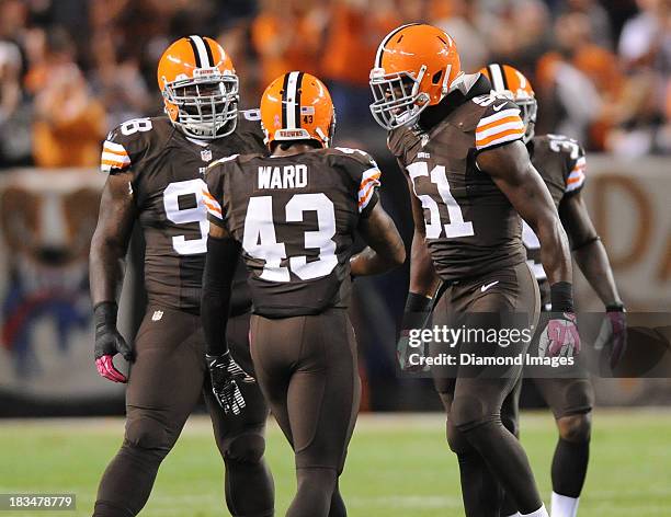 Defensive back T.J. Ward, linebacker Barkevious Mingo, and defensive linemen Phil Taylor of the Cleveland Browns celebrate after a tackle during a...