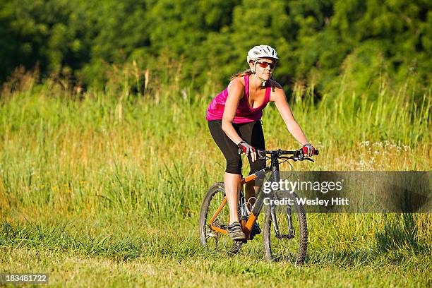 middle aged womanon bike - fayetteville foto e immagini stock