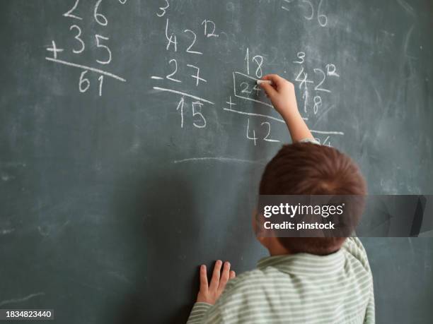 cute honored child at front of chalkboard. - honour board stock pictures, royalty-free photos & images