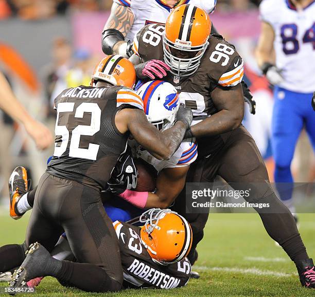 Running back Fred Jackson of the Buffalo Bills is tackled by linebackers D'Qwell Jackson, Craig Robertson and defensive linemen Phil Taylor of the...