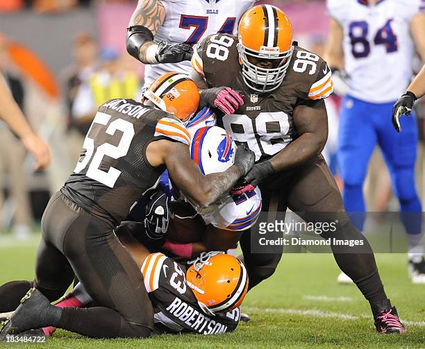 Running back Fred Jackson of the Buffalo Bills is tackled by linebackers D'Qwell Jackson, Craig Robertson and defensive linemen Phil Taylor of the...