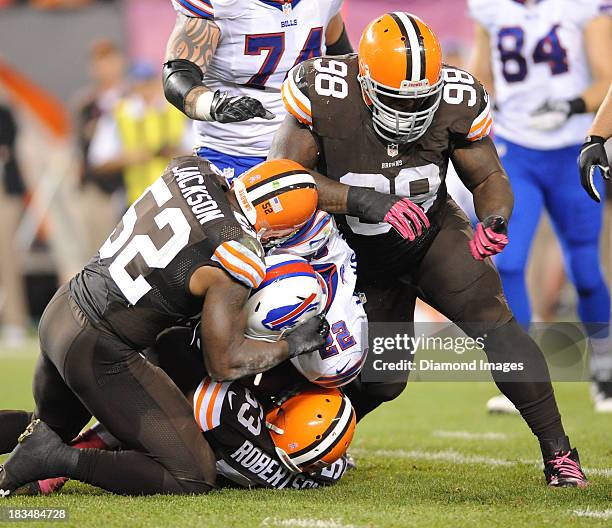 Running back Fred Jackson of the Buffalo Bills is tackled by linebackers D'Qwell Jackson, Craig Robertson and defensive linemen Phil Taylor of the...