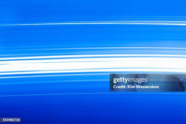 bright white lights moving on blue - westerskov stock pictures, royalty-free photos & images