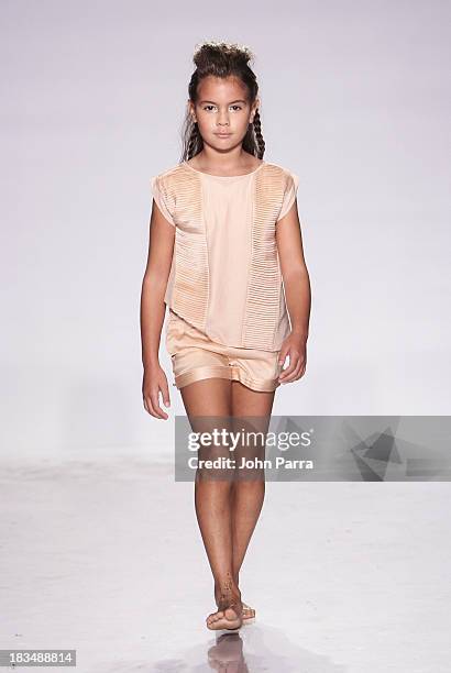 Model walks the runway at the Pale Cloud show during petiteParade NY Fashion Week in Collaboration with Voguebambini at the Industria Superstudio on...