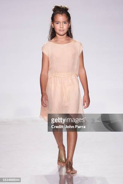 Model walks the runway at the Pale Cloud show during petiteParade NY Fashion Week in Collaboration with Voguebambini at the Industria Superstudio on...