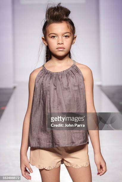 Model walks the runway at the Pale Cloud show during petiteParade NY Fashion Week in Collaboration with Voguebambini at the Industria Superstudio on...