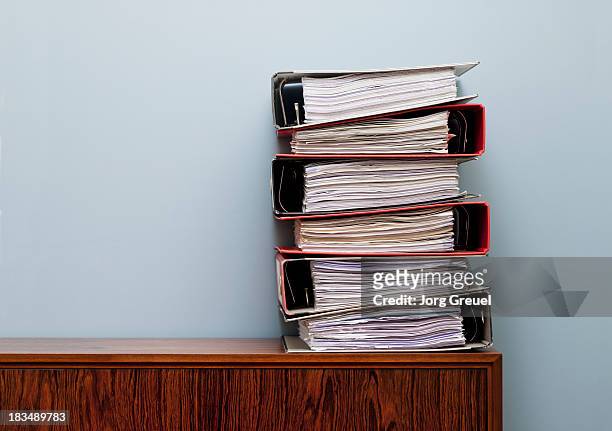 ring binders on cabinet - pile of paper stockfoto's en -beelden