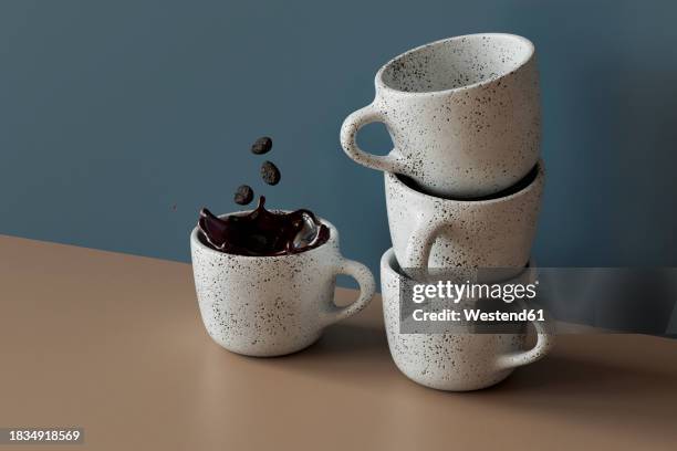 3d render of coffee beans falling into mug of coffee standing by stack of empty mugs - coffee beans falling stock illustrations