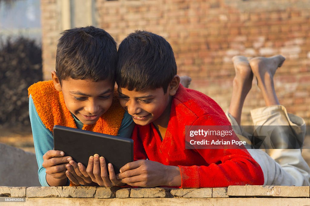 Two Indian boys using tablet device