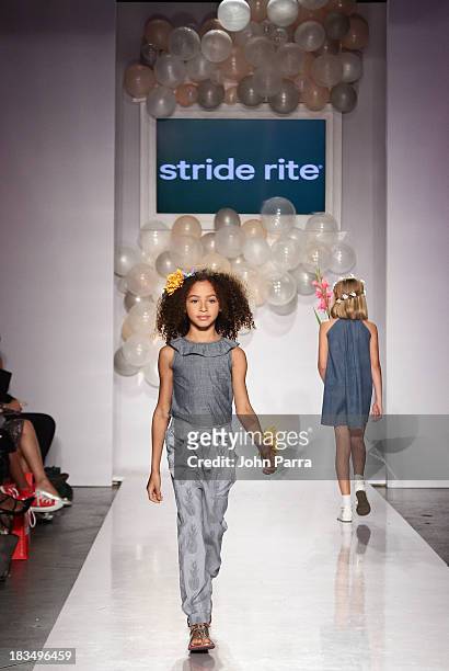 Model walks the runway at the Stride Rite show during the petiteParade NY Kids Fashion Week in Collaboration with VOGUE Bambini on October 6, 2013 in...