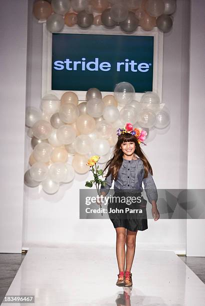 Model walks the runway at the Stride Rite show during the petiteParade NY Kids Fashion Week in Collaboration with VOGUE Bambini on October 6, 2013 in...