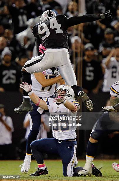 Linebacker Kevin Burnett of the Oakland Raiders hurdles running back Danny Woodhead of the San Diego Chargers to put pressure on quarterback Philip...