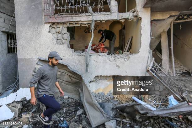 Residents living in the area, examine search for their furniture under the rubbles of the destroyed buildings after Israeli attacks in Rafah, Gaza on...