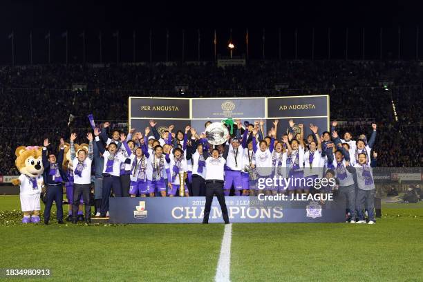 Head coach Hajime Moriyasu of Sanfrecce Hiroshima lifts the J.League Champions plaque at the award ceremony following the J.League Championship...